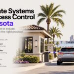 HOA gate systems and access control in Sarasota: gatehouse entrance with barrier arms, palm trees and a vehicle approaching the resident lane